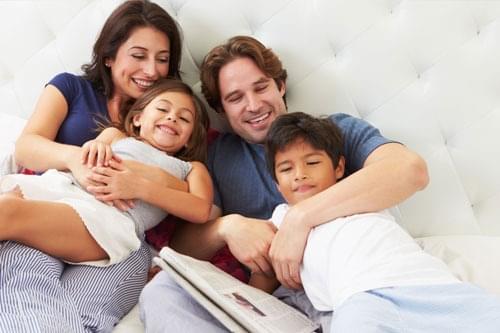 family waking up and alert in bed