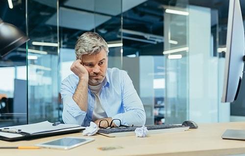 tired man at a desk