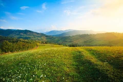 green hills with a sunrise