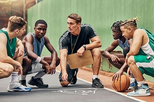 runners and a coach huddling